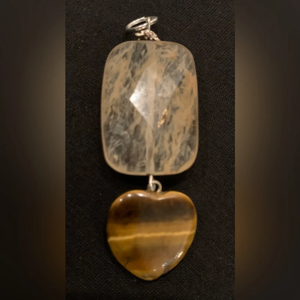 Rutilated quartz and a tigereye heart combine for a striking pendant. 2.75” - Picture 1 of 5